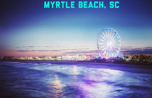 myrtle beach at night with pier and ferris wheel