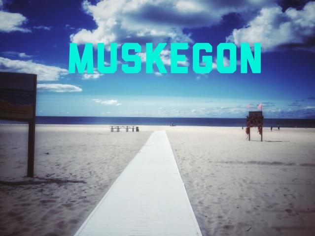 muskegon beach mat and clouds in blue sky